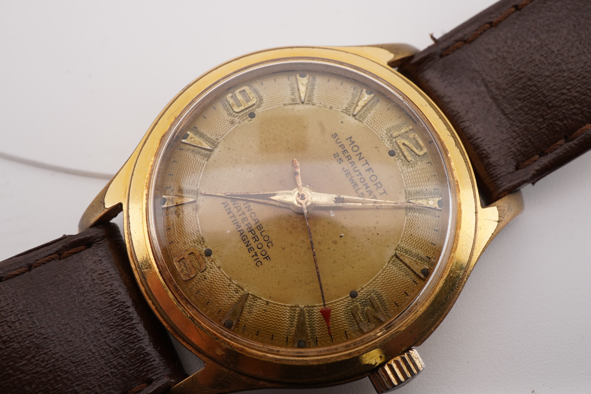 A gentleman's steel and gold plated Montfort Superautomatic wrist watch, with Roman and quarterly Arabic numerals, case diameter 34mm, on a later associated leather strap.